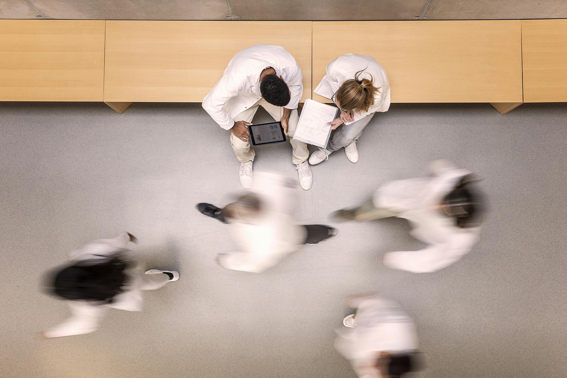 Aerial view of doctors walking and chatting in a hallway